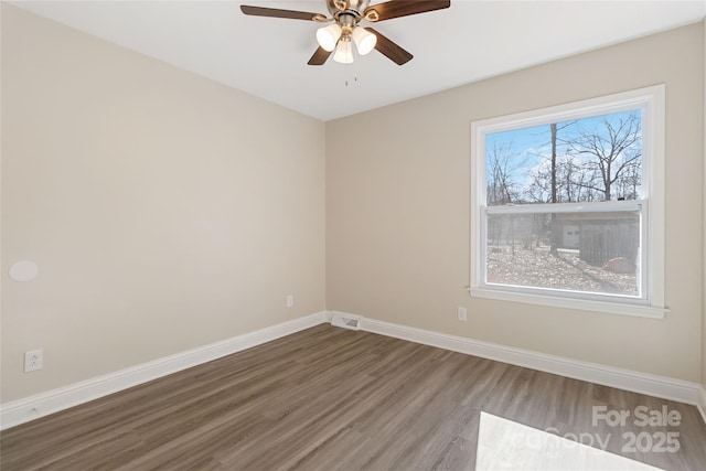 spare room with wood-type flooring and ceiling fan