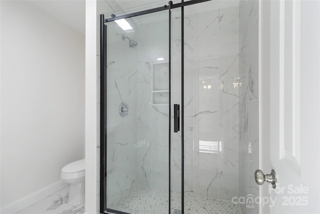 bathroom featuring toilet and an enclosed shower