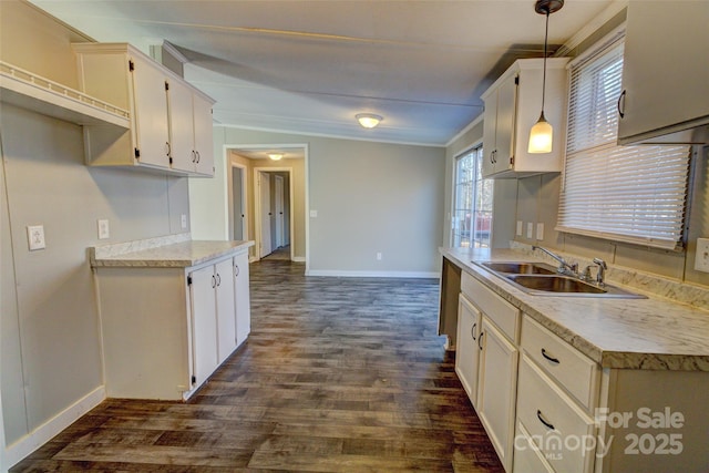 kitchen with pendant lighting, sink, dark hardwood / wood-style floors, and white cabinets