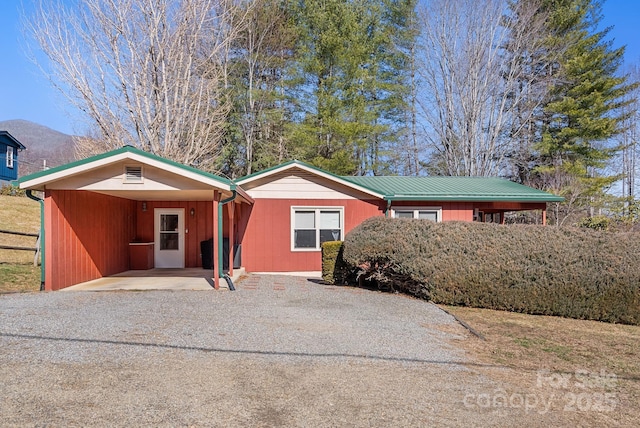 ranch-style home with a mountain view and a carport