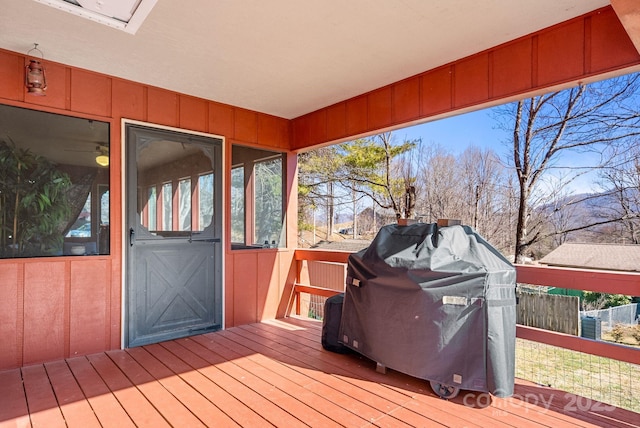 wooden terrace with a grill