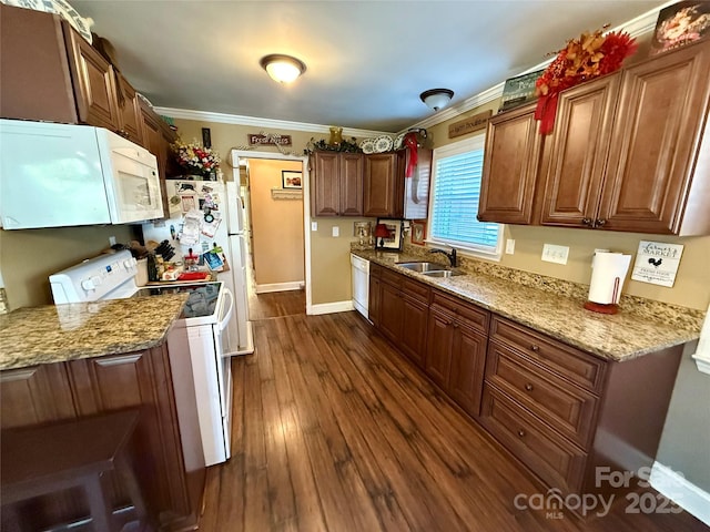 kitchen with sink, white appliances, dark hardwood / wood-style floors, ornamental molding, and light stone countertops