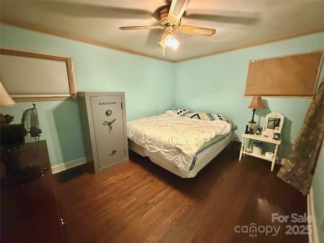 bedroom featuring dark wood-type flooring, ornamental molding, and ceiling fan