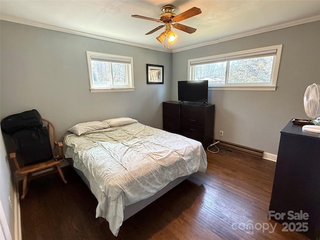 bedroom featuring dark wood-type flooring, ornamental molding, multiple windows, and a baseboard heating unit