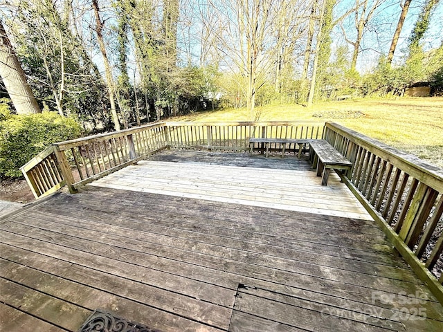 wooden deck featuring a yard