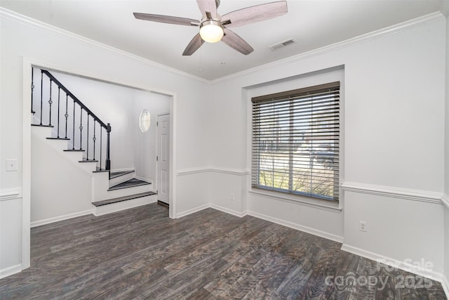 spare room with crown molding, dark wood-type flooring, and ceiling fan