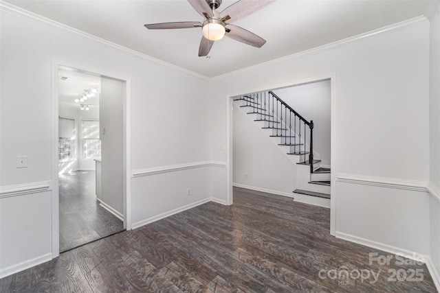 empty room with dark wood-type flooring, ornamental molding, and ceiling fan