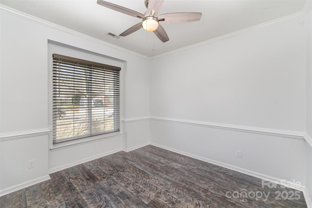 empty room featuring crown molding, dark wood-type flooring, and ceiling fan