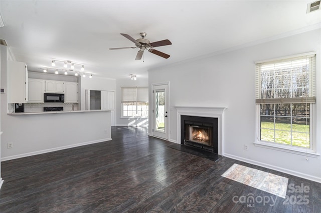 unfurnished living room featuring dark wood-type flooring, ceiling fan, and ornamental molding