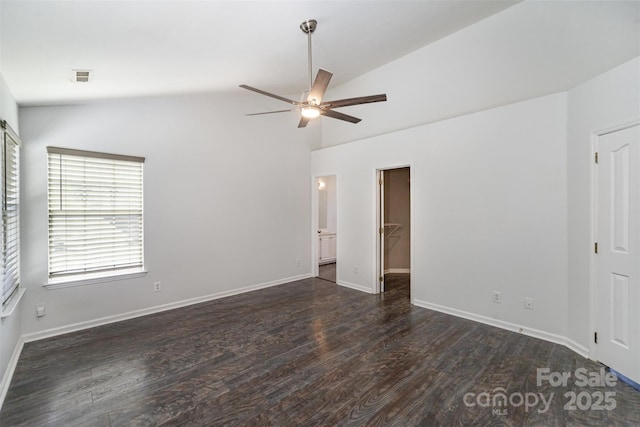 interior space with a spacious closet, vaulted ceiling, dark hardwood / wood-style floors, a closet, and ceiling fan