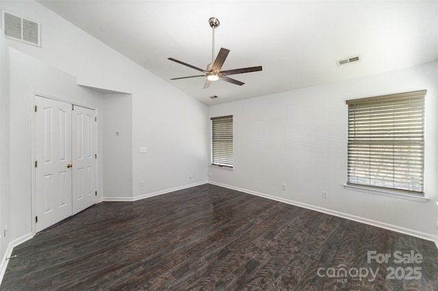 spare room featuring ceiling fan, dark hardwood / wood-style floors, and vaulted ceiling