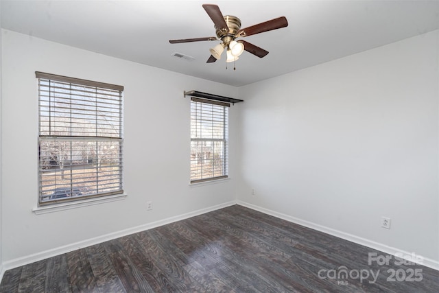 empty room featuring dark wood-type flooring and ceiling fan