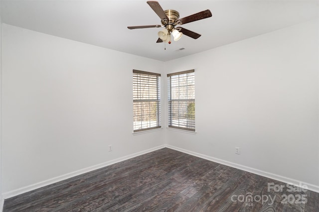 unfurnished room with ceiling fan and dark hardwood / wood-style flooring