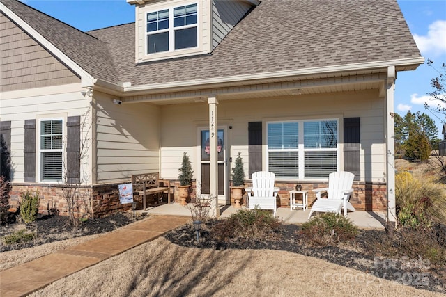 rear view of property featuring a porch