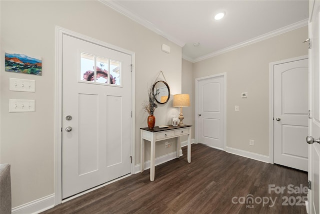 foyer with ornamental molding and dark hardwood / wood-style floors