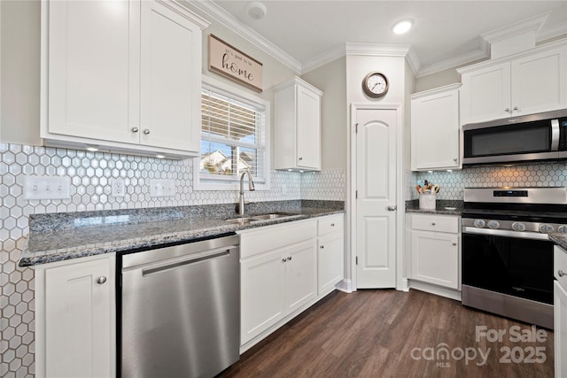 kitchen with white cabinetry, appliances with stainless steel finishes, sink, and crown molding