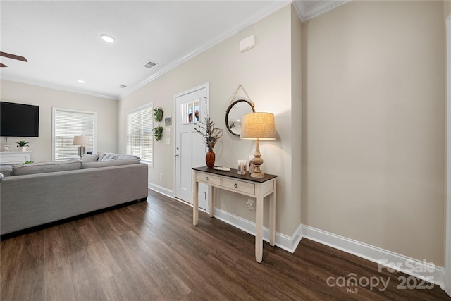 living room with crown molding, dark wood-type flooring, and ceiling fan