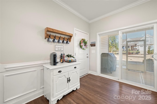 entryway featuring ornamental molding and dark hardwood / wood-style flooring