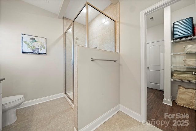 bathroom with walk in shower and toilet