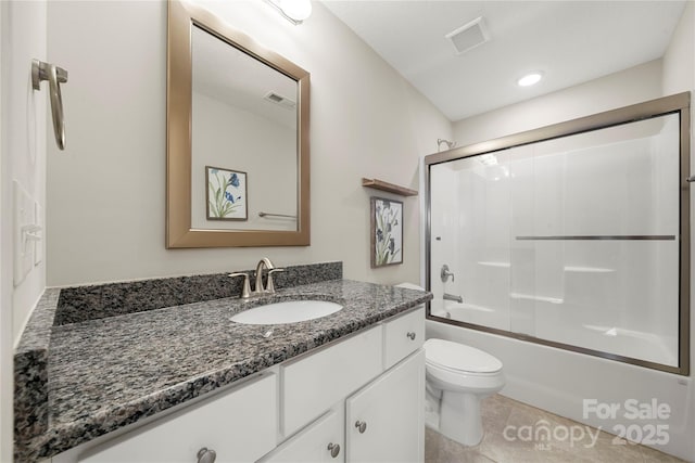 full bathroom featuring vanity, tile patterned floors, toilet, and combined bath / shower with glass door