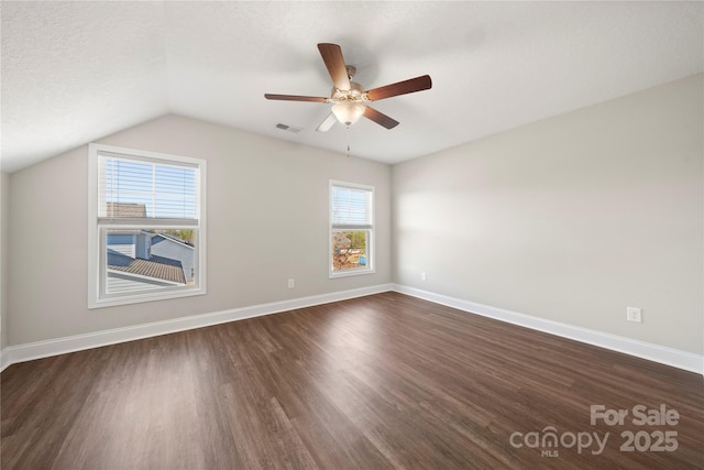 interior space with ceiling fan, lofted ceiling, dark hardwood / wood-style flooring, and a textured ceiling