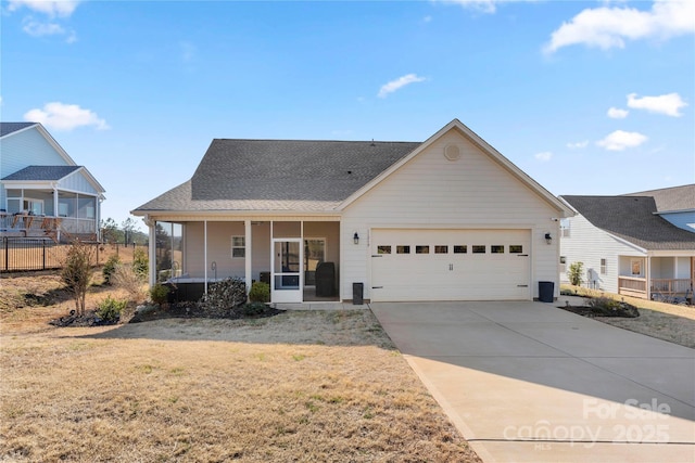 view of front of home with a garage, a front yard, and covered porch