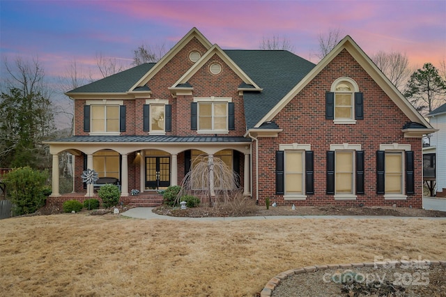 view of front of home with a yard and a porch