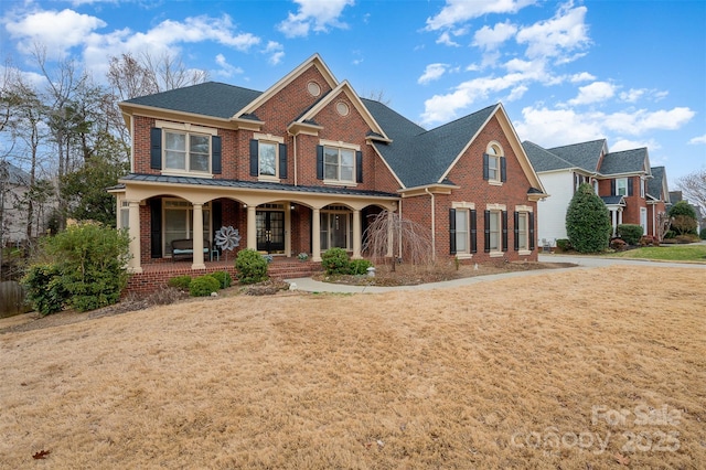 view of front facade with covered porch and a front lawn