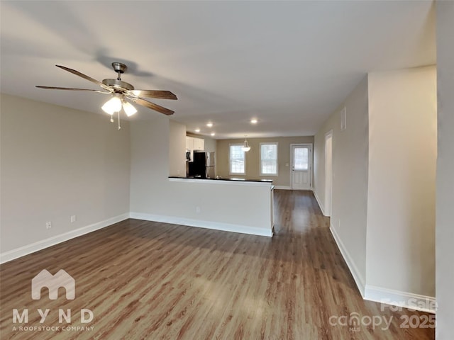 unfurnished living room with ceiling fan and light hardwood / wood-style floors