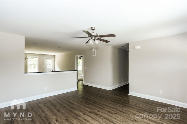 unfurnished room with dark wood-type flooring and ceiling fan