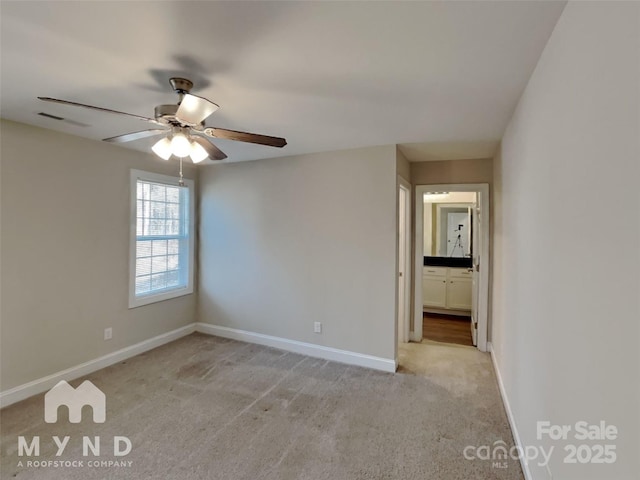 carpeted spare room with ceiling fan