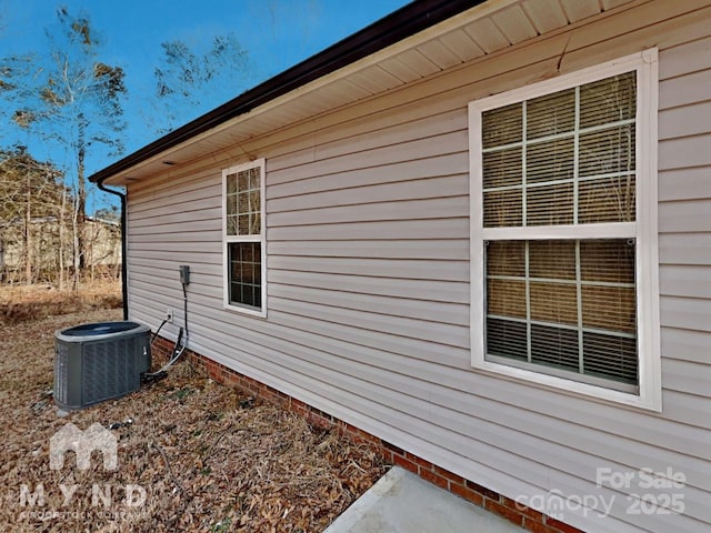 view of side of home featuring central AC