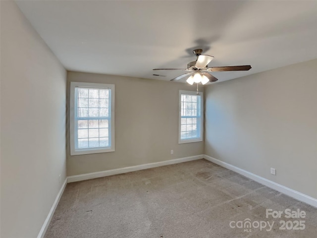 carpeted spare room featuring ceiling fan