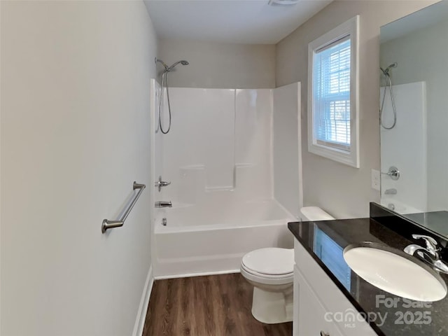 full bathroom featuring vanity, toilet, shower / washtub combination, and hardwood / wood-style floors