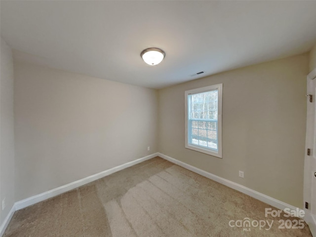 empty room featuring light colored carpet