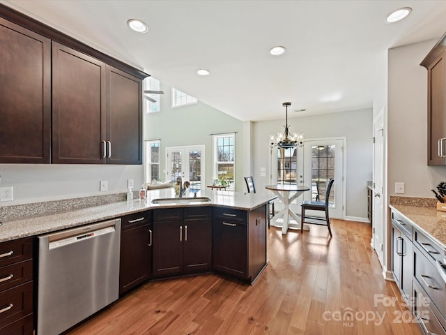 kitchen with sink, dishwasher, dark brown cabinets, light stone counters, and french doors