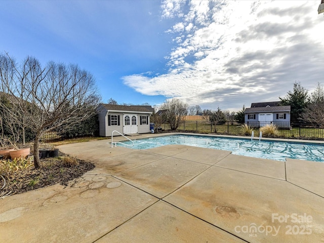 view of pool featuring an outbuilding and a patio