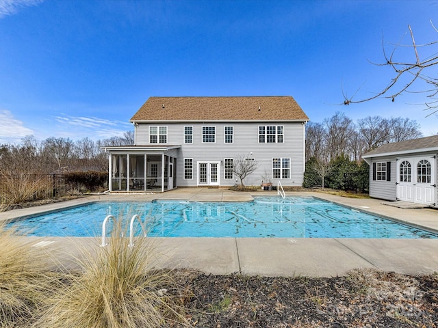 view of pool with a patio area and a sunroom