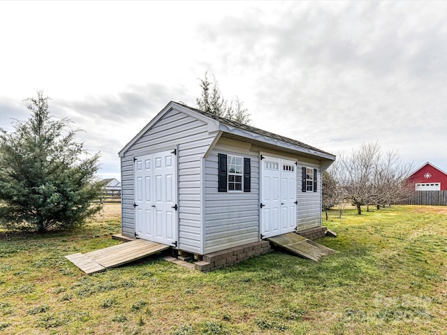 view of outbuilding featuring a yard