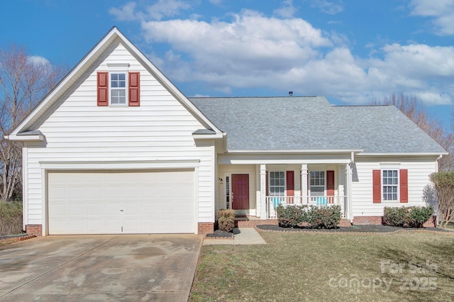 view of property with a garage, covered porch, and a front yard