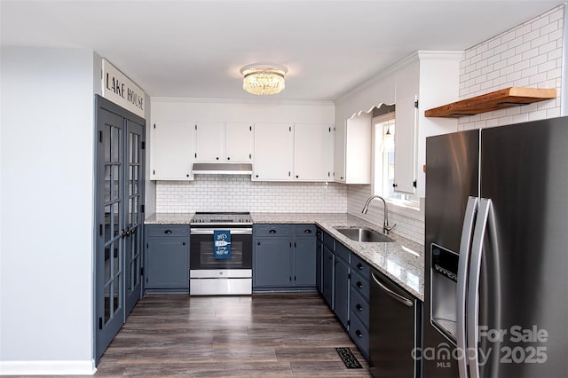 kitchen with white cabinetry, blue cabinetry, stainless steel appliances, and sink