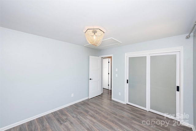 unfurnished bedroom featuring dark hardwood / wood-style flooring