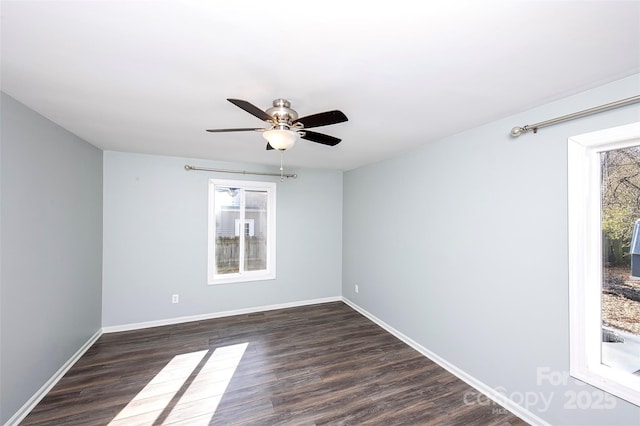 empty room featuring dark wood-type flooring and ceiling fan