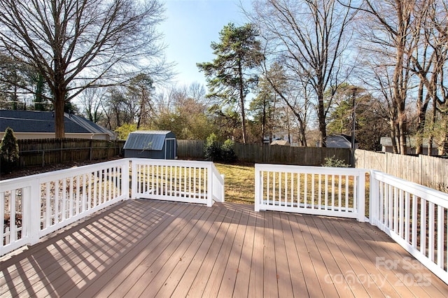 wooden terrace featuring a storage shed