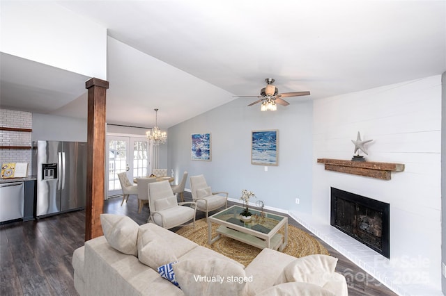 living room featuring vaulted ceiling, a fireplace, decorative columns, dark hardwood / wood-style flooring, and ceiling fan