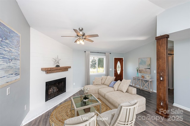 living room featuring vaulted ceiling, dark hardwood / wood-style floors, and ceiling fan