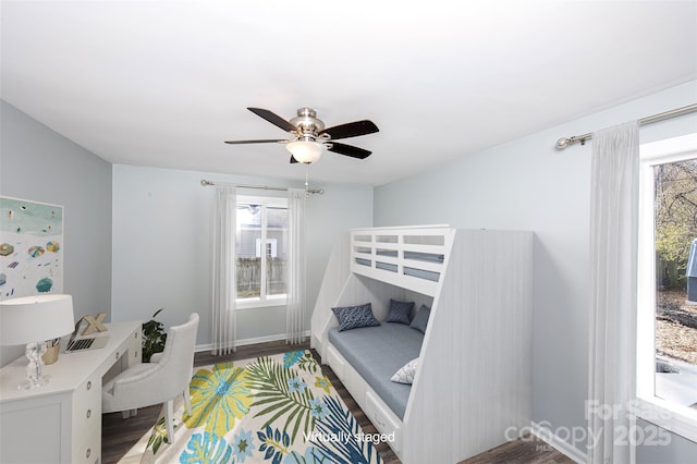 bedroom with hardwood / wood-style flooring, ceiling fan, and multiple windows