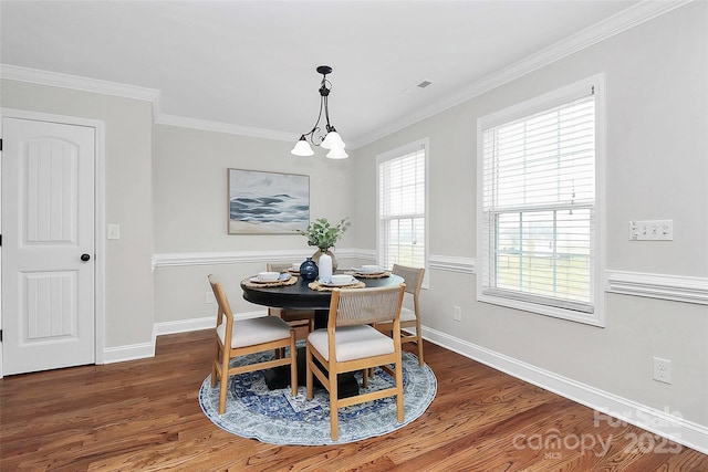 dining room featuring crown molding, visible vents, dark wood finished floors, and baseboards