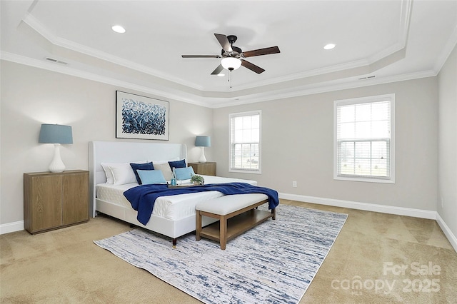 bedroom featuring light carpet, a tray ceiling, visible vents, and baseboards