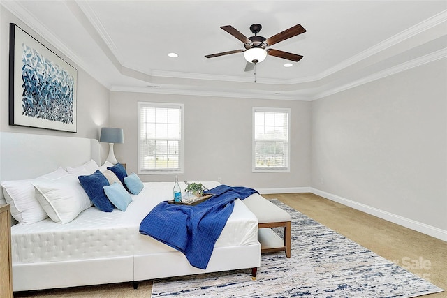 bedroom with carpet, baseboards, a raised ceiling, and ornamental molding